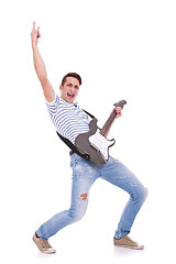 Image showing young casual man playing an electric guitar 