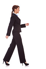 Image showing side view of a young business woman walking