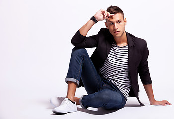 Image showing fashionable young casual man sitting