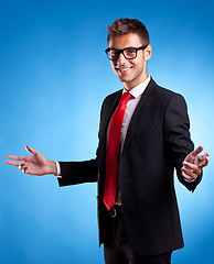 Image showing Smiling business man welcoming