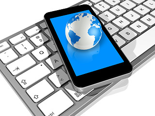 Image showing world globe on a mobile phone on a computer keyboard