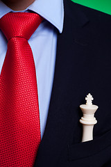 Image showing  chess king in the pocket of a business man