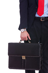 Image showing Business man in black suit hand holding briefcase