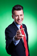 Image showing young business man points finger 