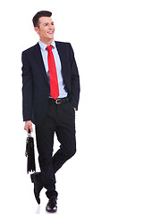 Image showing young business man with suitcase looking to side