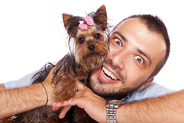 Image showing young man holding a cute yorkie puppy dog