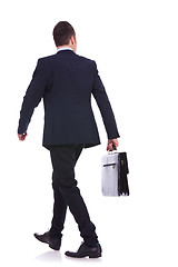 Image showing back of a walking business man holding a briefcase 