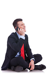Image showing seated young business man talking on the phone