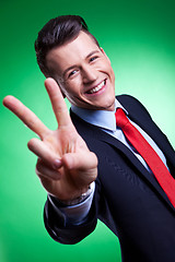 Image showing business man in a suit giving the victory sign