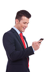 Image showing business man reading an SMS on cellphone