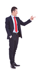 Image showing  handsome young business man pointing to his side