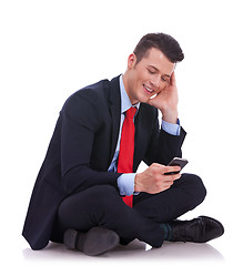 Image showing business man sending or reading a text message