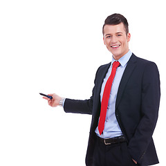 Image showing  business man in a suit pointing with a pen