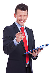 Image showing Casual Business man With a Clipboard pointing