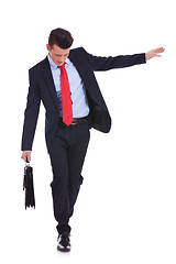 Image showing Business man with slow walking with fear from falling