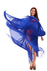 Image showing happy young woman in blue long wavy dress 