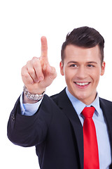 Image showing business man pushing imaginary buttons