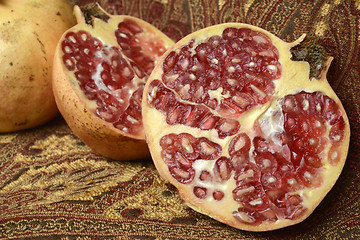 Image showing two pomegranates, one open in the foreground