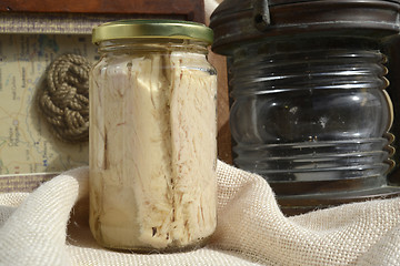 Image showing tuna canned in glass jar and maritime motifs