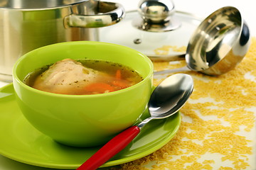 Image showing Soup in bowl and stainless steel pan.