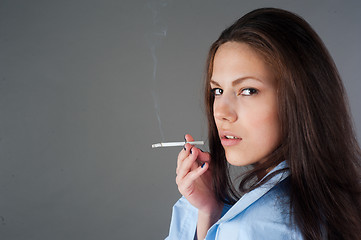 Image showing beautiful young brunette woman with cigarette
