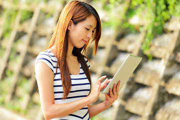 Image showing young asian woman with tablet computer outdoor