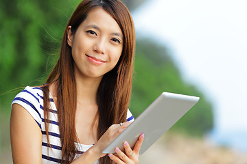 Image showing young asian woman with tablet outdoor