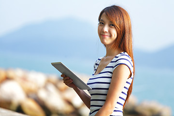 Image showing young asian woman with tablet outdoor