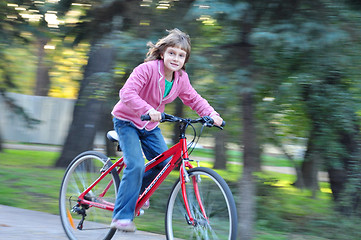 Image showing Cute Happy girl riding bike