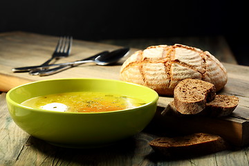 Image showing Chicken soup with poached egg .