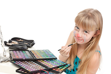 Image showing Little girl paints his face makeup