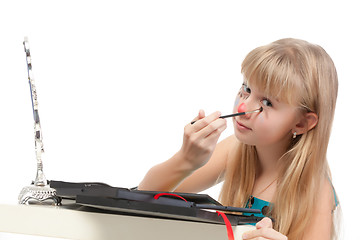 Image showing Little girl paints his face makeup