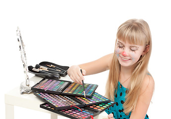 Image showing Little girl paints his face makeup