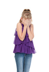 Image showing Young girl shyly covered her face with her hands