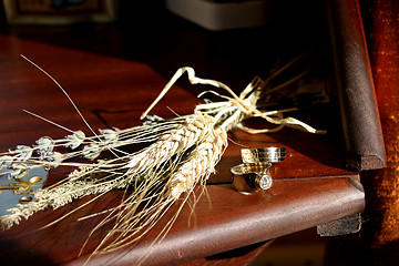 Image showing Wedding rings and wheat