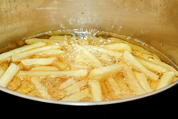 Image showing French fries frying in hot oil