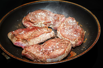 Image showing beef meat on pan with pepper and sea salt