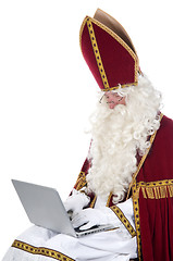 Image showing Sinterklaas using a laptop