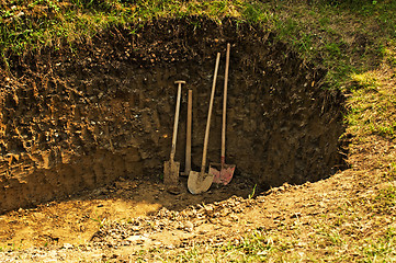 Image showing hole with shovel,spade and hoe