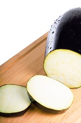 Image showing sliced Aubergine in kitchen Board isolated on white