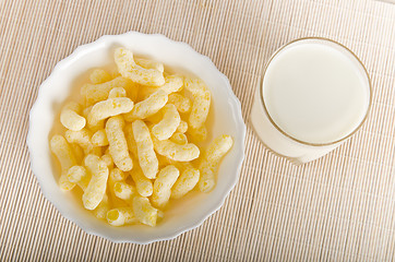 Image showing Breakfast. A glass of milk and corn flakes 