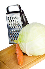 Image showing Cabbage and carrots on a kitchen board, it is isolated on white