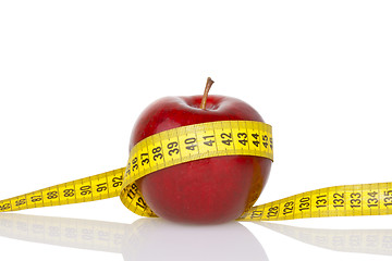 Image showing Red apple with measure tape