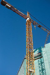 Image showing Construction site: crane and unfinished buiding