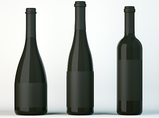 Image showing Three corked bottles for wine with black labels 