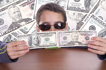 Image showing boy blinded by money, studio photo