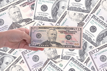 Image showing hand holding a dollar bill, business studio photo