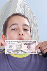 Image showing boy blinded by money, studio photo