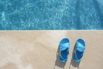 Image showing Slippers near swimming pool, summer vacations