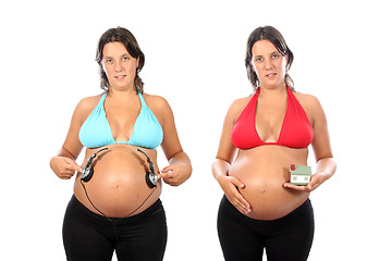 Image showing beautiful pregnant woman with headphones in belly